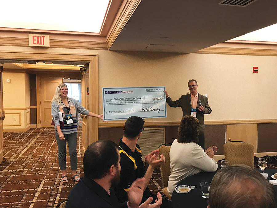 NNA Executive Director Lynne Lance and Bill Coady, Walterry Insurance Brokers, present a display check for $1,262,629, showing Walterry's support of NNA over the years since 1979.