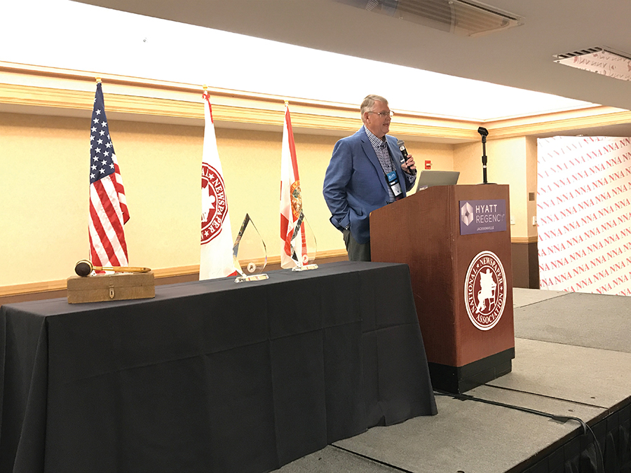 Larry Atkinson, retired, Mobridge, South Dakota, speaks after being awarded with one of  the highest and most dignified tributes in community journalism, the James O. Amos Award. The Amos Award is presented to a working or retired newspaperman who has provided distinguished service and leadership to the community press and their community.