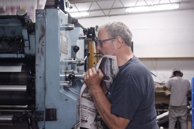 Zane Taylor and Jose Santana print The Times-Independent’s B section on July 18, 2023. (Photo by Doug McMurdo, Times-Independent)