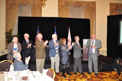 Jeff Egbert, Publishers  Auxiliary | At the 133th Annual Convention & Trade Show in Milwaukee, Wisconsin, past presidents passed the gavel down the line, from left: Diane Everson, Reed Anfinson, Robert Williams Jr., Matt Paxton, Susan Rowell, Immediate Past President Andrew Johnson and President Matt Adelman.