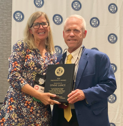 In late September as his two-year term as NNA Foundation president was coming to an end, R. Michael Fishman, publisher of the Citizen Tribune in Morristown, Tennessee, presented the President’s Award to NNA Executive Director Lynne Lance at the Annual Convention and Trade Show in Omaha, Nebraska. In late September as his two-year term as NNA Foundation president was coming to an end, R. Michael Fishman, publisher of the Citizen Tribune in Morristown, Tennessee, presented the President’s Award to NNA Executive Director Lynne Lance at the Annual Convention and Trade Show in Omaha, Nebraska.