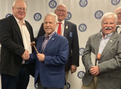 The NNA Foundation president’s gavel passed from Matt Adelman (left), publisher of the Douglas (Wyoming) Budget to Mike Fishman (forefront right), publisher, Lakeway Publishers in Morristown, Tennessee. Adelman became vice president. In the background, past presidents John Galer (background left), NNA chair, and Steven Haynes (background right), Haynes Publishing, Inc, Oberlin, Kansas, join them in celebrating.