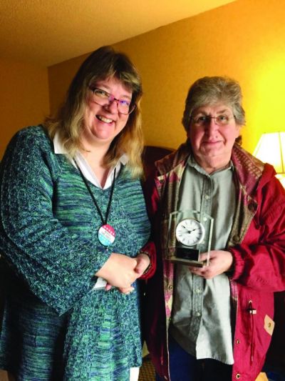 Terry Hamberg (left) congratulates Jerri Stoner on receiving the Washington Newspaper Publishers Association s 2016 Dixie Lee Bradley Award at the annual WNPA convention. The Dixie Lee Bradley Award is presented to one newspaper industry employee each year for “consistent, quality work over a considerable time period in any facet of the community newspaper industry.”  Oahe Publishing Corporation is the parent company of the Northern Kittitas County Tribune and owned by Jana Stoner, president, Terry Hamberg, vice president, and Jerri Stoner, secretary/treasurer.