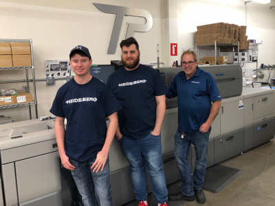 Jonathon Long, prepress/design at Time Printing Solutions Provider; Kyle Friesner, digital operator at Time Printing Solutions Prover; and Andy Poole, president of Time Printing Solutions Provide, in front of the Versafire EP